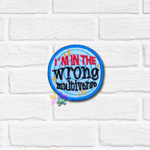 Round patch with text 'I'm in the wrong multiverse' on a white brick background