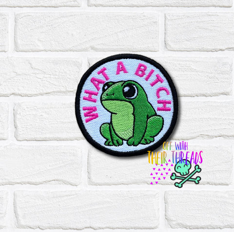 Patch with a green frog and text on a white brick background